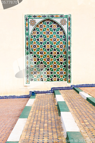 Image of blue window in morocco africa   and brown wall  construction