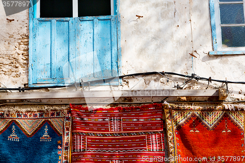 Image of blue window in morocco  wall red carpet