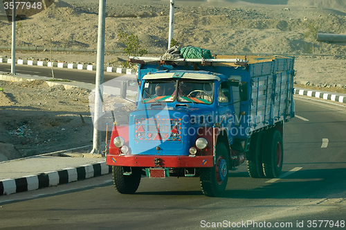 Image of Old truck with arabian people on road of Egypt