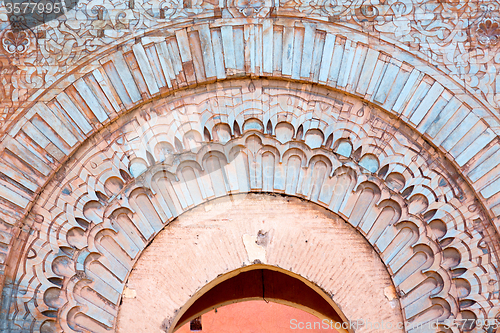 Image of blue  window in  construction and brown wall  