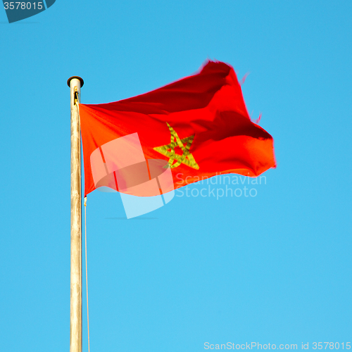 Image of tunisia  waving flag in the blue sky  colour and battlements  wa