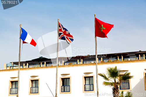 Image of world waving flag in the blue sky  colour  morocco