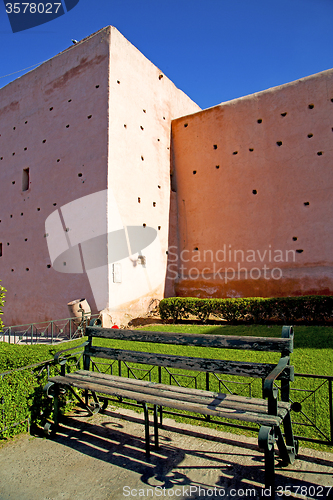 Image of brown  old ruin in   bench garden  grass  morocco and sky   