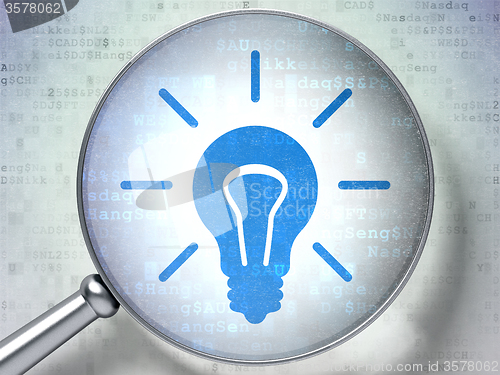 Image of Finance concept: Light Bulb with optical glass on digital background