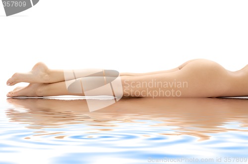 Image of long legs of relaxed lady in water