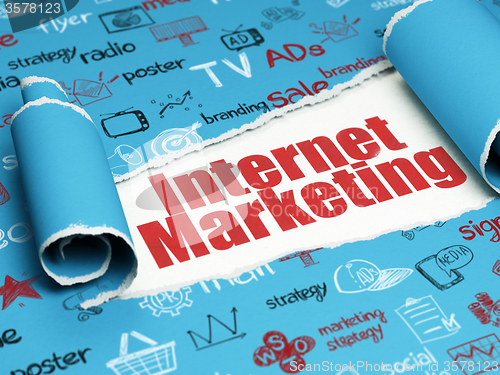 Image of Marketing concept: red text Internet Marketing under the piece of  torn paper