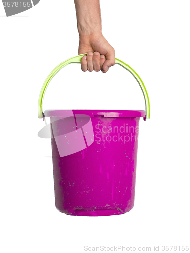 Image of Human hand holding empty plastic pail