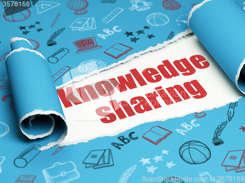 Image of Education concept: red text Knowledge Sharing under the piece of  torn paper