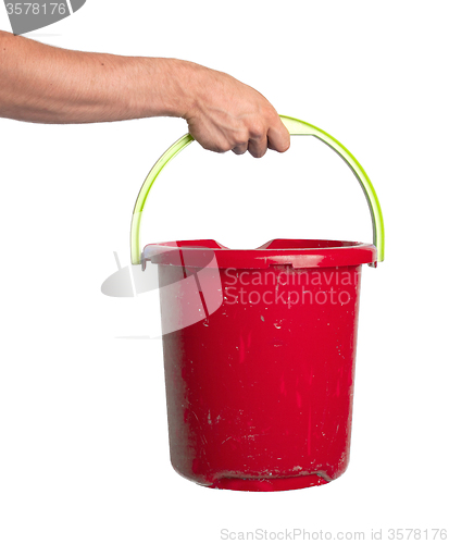 Image of Human hand holding empty plastic pail