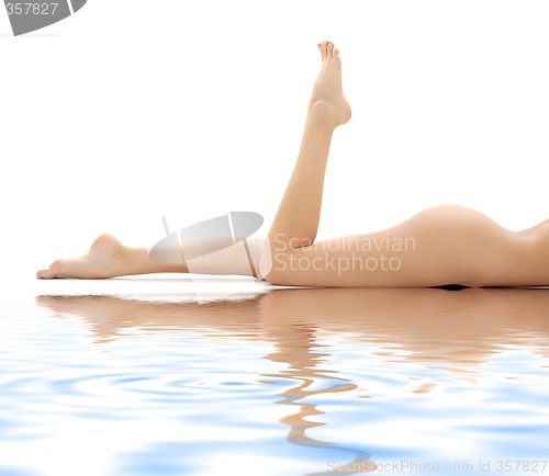 Image of long legs of relaxed lady in water #2