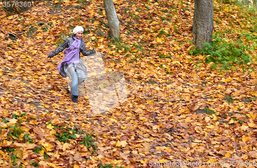 Image of girl run in bright yellow autumn forest