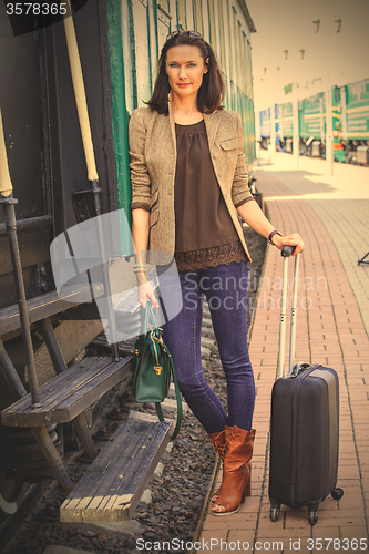 Image of woman on the steps of an old passenger rail car