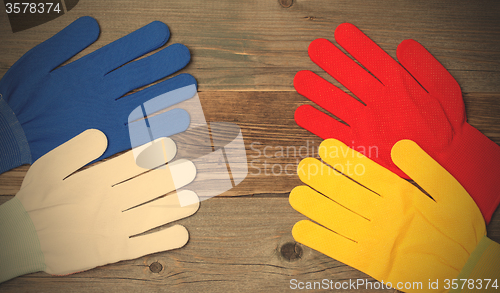 Image of four new working multicolored gloves