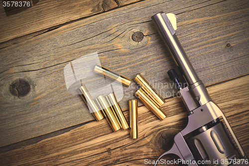 Image of revolver and seven cartridges
