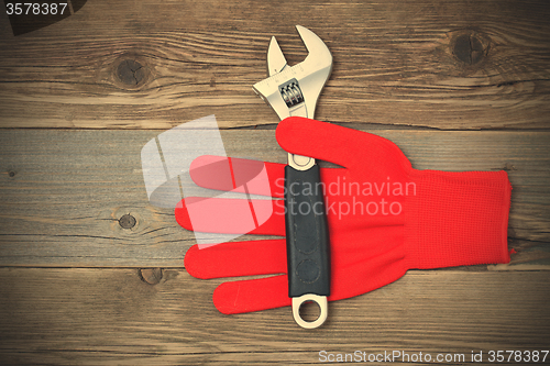 Image of Red construction glove with wrench