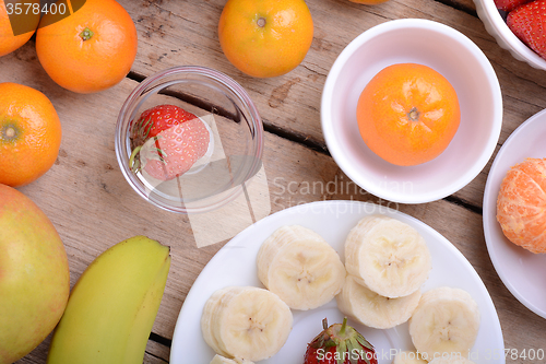 Image of Fresh colorful fruits composition mandarin, strawberry, peach, bananas and orange