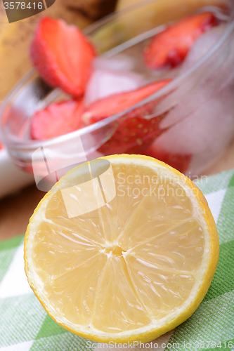 Image of Close up of a cup of sliced strawberries with lemon