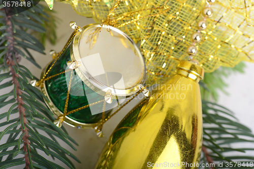 Image of Christmas background with drums, green eve tree branch, golden new year decoration 