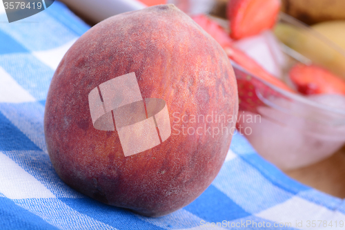 Image of peach strawberry bananas mandarin close up as health food concept