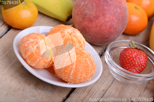 Image of Fresh colorful fruits composition mandarin, strawberry, peach, bananas and orange
