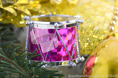 Image of Christmas background with drums, green eve tree branch, golden new year decoration 