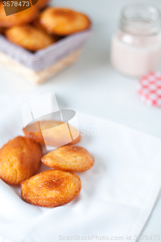 Image of Madeleine small traditional French desserts with strawberries