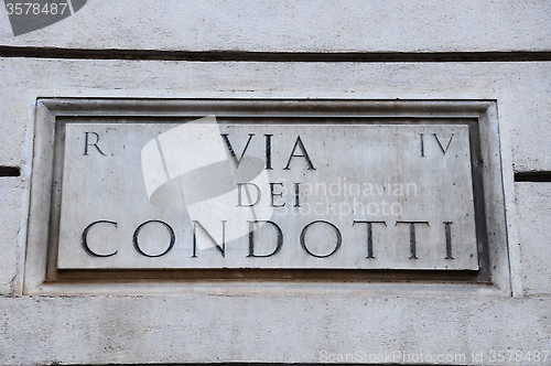 Image of Road sign indicating a street name in Italian "Via dei condotti 