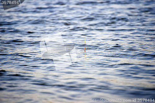 Image of Fishing background: float bobs on the waves.