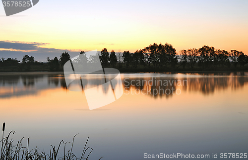 Image of The morning landscape with sunrise over water in the fog