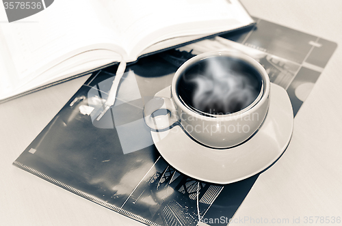 Image of Cup of coffee on the desk in the office