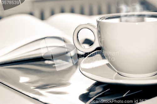 Image of Cup of coffee on the desk in the office