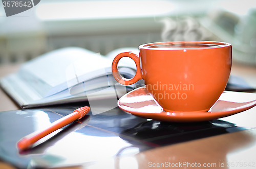 Image of Cup of coffee on the desk in the office