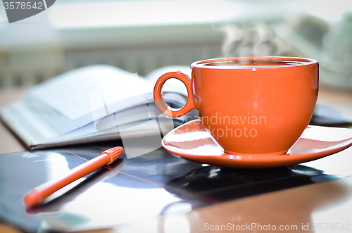 Image of Cup of coffee on the desk in the office