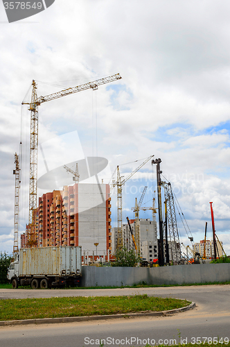 Image of Cranes and building construction on the background of clouds