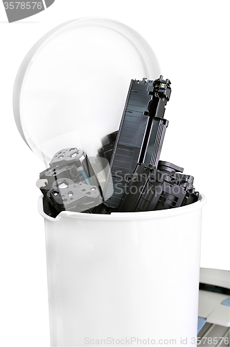 Image of Cartridges from the printer in the trash can, standing on a prin