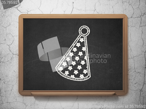Image of Holiday concept: Party Hat on chalkboard background