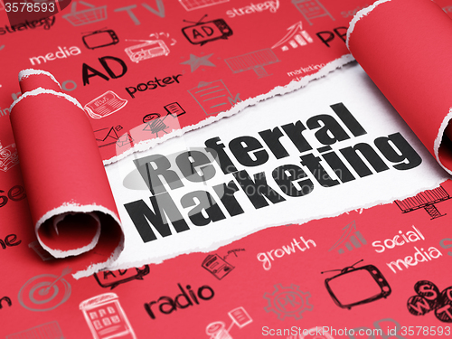 Image of Advertising concept: black text Referral Marketing under the piece of  torn paper