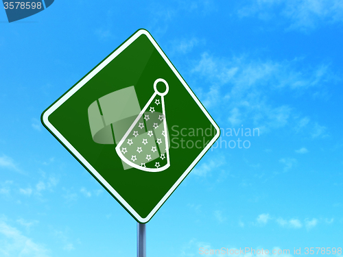 Image of Holiday concept: Party Hat on road sign background