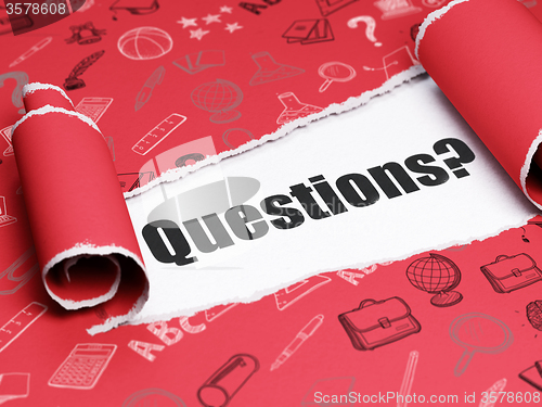 Image of Education concept: black text Questions? under the piece of  torn paper