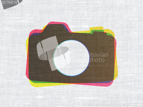 Image of Tourism concept: Photo Camera on fabric texture background