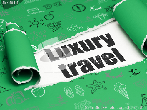 Image of Vacation concept: black text Luxury Travel under the piece of  torn paper