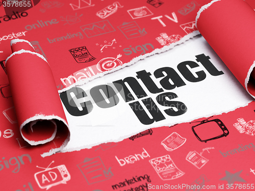 Image of Marketing concept: black text Contact Us under the piece of  torn paper