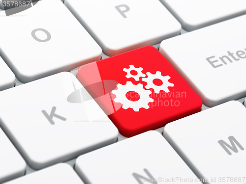 Image of Web design concept: Gears on computer keyboard background