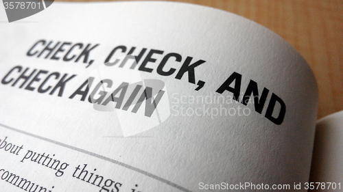 Image of Check again word on a book