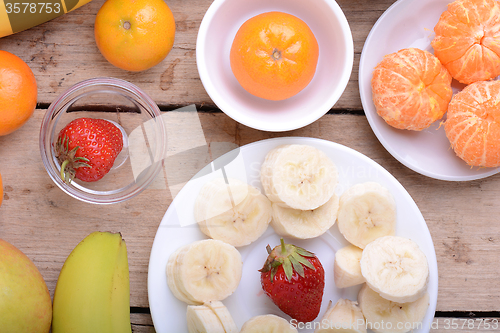 Image of Fresh colorful fruits composition mandarin, strawberry, peach, bananas and orange
