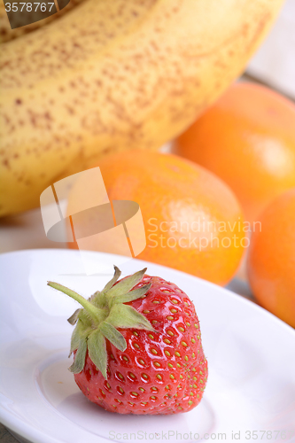 Image of Fresh colorful fruits composition mandarin, strawberry, peach, bananas and orange