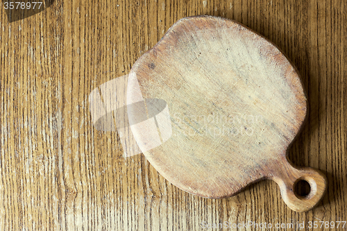 Image of old wooden apple shape cutting board on the table