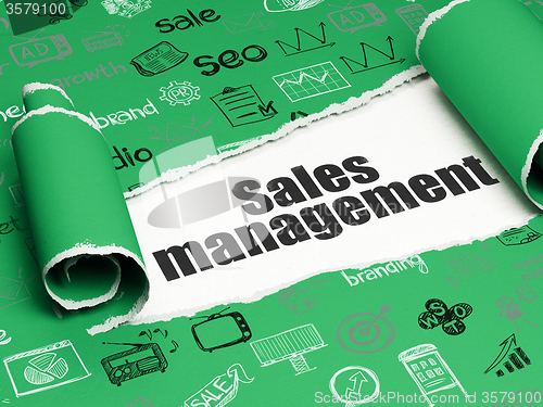 Image of Advertising concept: black text Sales Management under the piece of  torn paper
