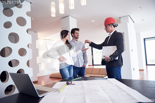 Image of couple buying new home with real estate agent