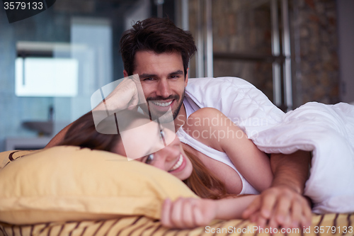 Image of couple relax and have fun in bed